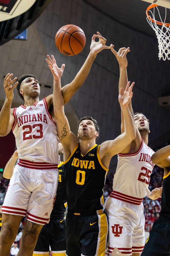 Indiana Hoosiers forward Trayce Jackson-Davis (23), forward Race Thompson (25) and Iowa Hawkeyes forward Filip Rebraca (0) fight for a rebound in the first half at Simon Skjodt Assembly Hall.